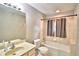 Bathroom featuring a bathtub/shower combo with gray curtains, a toilet, and a sink with vanity at 103 13Th Se St, Winter Haven, FL 33880