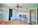 A bedroom featuring wood-look flooring, a ceiling fan, and a built-in closet at 103 13Th Se St, Winter Haven, FL 33880