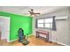 Bedroom features include light wood flooring, desk, ceiling fan, window, and a painted green wall at 103 13Th Se St, Winter Haven, FL 33880