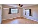 Bedroom with wood-look flooring, windows, and a ceiling fan, perfect for relaxing at 103 13Th Se St, Winter Haven, FL 33880