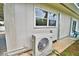Home exterior shows an outdoor A/C unit and a view of a small patio with a green chair at 103 13Th Se St, Winter Haven, FL 33880