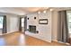 Living room featuring a white brick fireplace with a mantel and wood-look tile flooring at 103 13Th Se St, Winter Haven, FL 33880