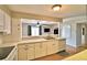 Kitchen with white countertops and cabinetry, open to the living room with a breakfast bar at 103 13Th Se St, Winter Haven, FL 33880