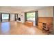 Living room featuring a fireplace, wood-look tile flooring, and lots of natural light from the windows at 103 13Th Se St, Winter Haven, FL 33880