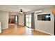 Living room with sliding glass doors, ceiling fan, and a view into another room with desk at 103 13Th Se St, Winter Haven, FL 33880