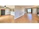 Open living room with wood-look tile flooring, a ceiling fan, natural light, and a view into the kitchen at 103 13Th Se St, Winter Haven, FL 33880