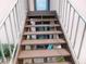 Exterior staircase with wooden steps and a metal railing for access to a second story or upper-level unit at 218 La Casa, Lake Wales, FL 33898