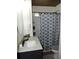 Bathroom with sink, counter and tiled shower with patterned curtain at 218 Steedly Ave, Lake Wales, FL 33853