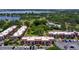 Aerial view of community condominiums surrounded by lush landscaping and a picturesque lake at 220 La Casa # 220, Lake Wales, FL 33898