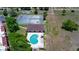 Overhead photo capturing the pool, tennis court, and mature landscaping of the condo community at 220 La Casa # 220, Lake Wales, FL 33898