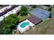 Aerial shot featuring a kidney-shaped pool, tennis court, and landscaping at condo community at 220 La Casa # 220, Lake Wales, FL 33898