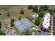 Breathtaking aerial photo of condo community pool and tennis court amidst serene surroundings at 220 La Casa # 220, Lake Wales, FL 33898