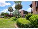 Charming backyard view featuring lush landscaping, mature trees, and screened patios at 220 La Casa # 220, Lake Wales, FL 33898