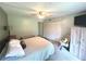 Bedroom featuring neutral carpet, a ceiling fan, and large closet with sliding door at 220 La Casa # 220, Lake Wales, FL 33898