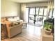 Bright and airy living room with modern furnishings and access to the outdoor patio at 220 La Casa # 220, Lake Wales, FL 33898