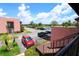 Upper level view of complex parking lot with well-kept grounds and building features at 220 La Casa # 220, Lake Wales, FL 33898
