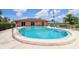 Sparkling blue community pool with ample seating and clear skies, promising relaxation at 220 La Casa # 220, Lake Wales, FL 33898