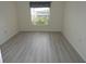 Bright bedroom with large window and wood-look flooring at 231 Lake Suzanne Dr, Lake Wales, FL 33859