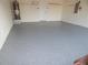 Garage with epoxy coated flooring at 231 Lake Suzanne Dr, Lake Wales, FL 33859