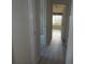 Hallway with wood-look floors and access to bedrooms and bath at 231 Lake Suzanne Dr, Lake Wales, FL 33859