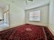 Empty bedroom with a window and carpet flooring, providing a blank canvas for personalization at 3017 Mission Lakes Dr, Lakeland, FL 33803