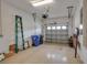 Spacious garage with a ladder, storage bins, and an automatic door at 3017 Mission Lakes Dr, Lakeland, FL 33803