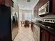 Eat-in kitchen features stainless steel appliances, dark cabinetry, and a breakfast nook with natural light at 3017 Mission Lakes Dr, Lakeland, FL 33803