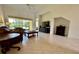 Bright living room with tile flooring, a ceiling fan, and large windows offering a view of the backyard at 3017 Mission Lakes Dr, Lakeland, FL 33803