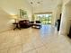 Spacious living room featuring tile floors, high ceilings, and a sliding glass door with abundant natural light at 3017 Mission Lakes Dr, Lakeland, FL 33803