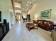 Open-concept living area with bar seating, high ceilings, and tile flooring leading to the front door at 3017 Mission Lakes Dr, Lakeland, FL 33803