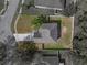 Drone overhead view of home with a well manicured lawn, mature trees, and a large driveway at 1029 Evans Loop, Lake Wales, FL 33853