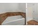 Bright bathroom features a soaking tub with decorative tile and a separate shower at 1029 Evans Loop, Lake Wales, FL 33853