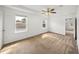 Neutral bedroom featuring neutral walls, carpeted floors, ceiling fan and two windows at 1029 Evans Loop, Lake Wales, FL 33853