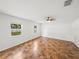 Bright bedroom with tile flooring, ceiling fan, and two windows offering natural light at 1029 Evans Loop, Lake Wales, FL 33853