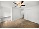 Neutral bedroom featuring a ceiling fan, closet, and attached desk area at 1029 Evans Loop, Lake Wales, FL 33853