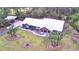 Blue house with white roof and landscaping, aerial view at 112 Reedy Creek Dr, Frostproof, FL 33843