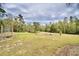 Spacious backyard with grassy area and wooded landscape at 112 Reedy Creek Dr, Frostproof, FL 33843