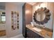 Bathroom with granite countertop, dark brown vanity, and decorative mirror at 112 Reedy Creek Dr, Frostproof, FL 33843