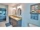 Elegant bathroom featuring double sinks, granite countertops, and decorative accents at 112 Reedy Creek Dr, Frostproof, FL 33843