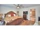 Large bedroom with king bed, ceiling fan, and ensuite bathroom at 112 Reedy Creek Dr, Frostproof, FL 33843