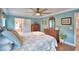 Main bedroom with ceiling fan and en-suite bathroom at 112 Reedy Creek Dr, Frostproof, FL 33843