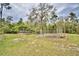 Landscaped backyard garden with raised beds and arbor at 112 Reedy Creek Dr, Frostproof, FL 33843