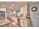 Bright kitchen featuring granite countertops, white cabinetry, and modern stainless steel appliances at 112 Reedy Creek Dr, Frostproof, FL 33843