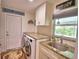 Laundry room with granite countertops, cabinets, and a utility sink at 112 Reedy Creek Dr, Frostproof, FL 33843