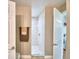 Modern shower stall with neutral tile and a bench, adjacent to the laundry area at 112 Reedy Creek Dr, Frostproof, FL 33843