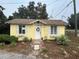 Yellow house with white shutters and a landscaped yard at 1120 S Scenic Hwy, Lake Wales, FL 33853