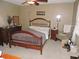 Spacious bedroom with wooden frame bed, dresser, and ceiling fan at 1163 Cephia St, Lake Wales, FL 33853