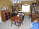 Formal dining room showcasing a rustic wooden table and period-appropriate furnishings at 1163 Cephia St, Lake Wales, FL 33853