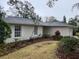 Light beige home with a two-car garage and well-maintained lawn at 1163 Cephia St, Lake Wales, FL 33853