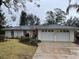 Ranch-style home with two-car garage and landscaped yard at 1163 Cephia St, Lake Wales, FL 33853